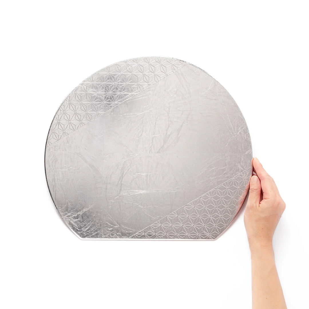 Silver Japanese Asanoha hemp leaf placemat with semicircular shape and embossed pattern for refined table.