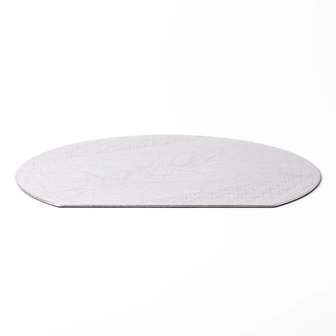 Silver Japanese Asanoha hemp leaf placemat with semicircular shape and embossed pattern for refined table.