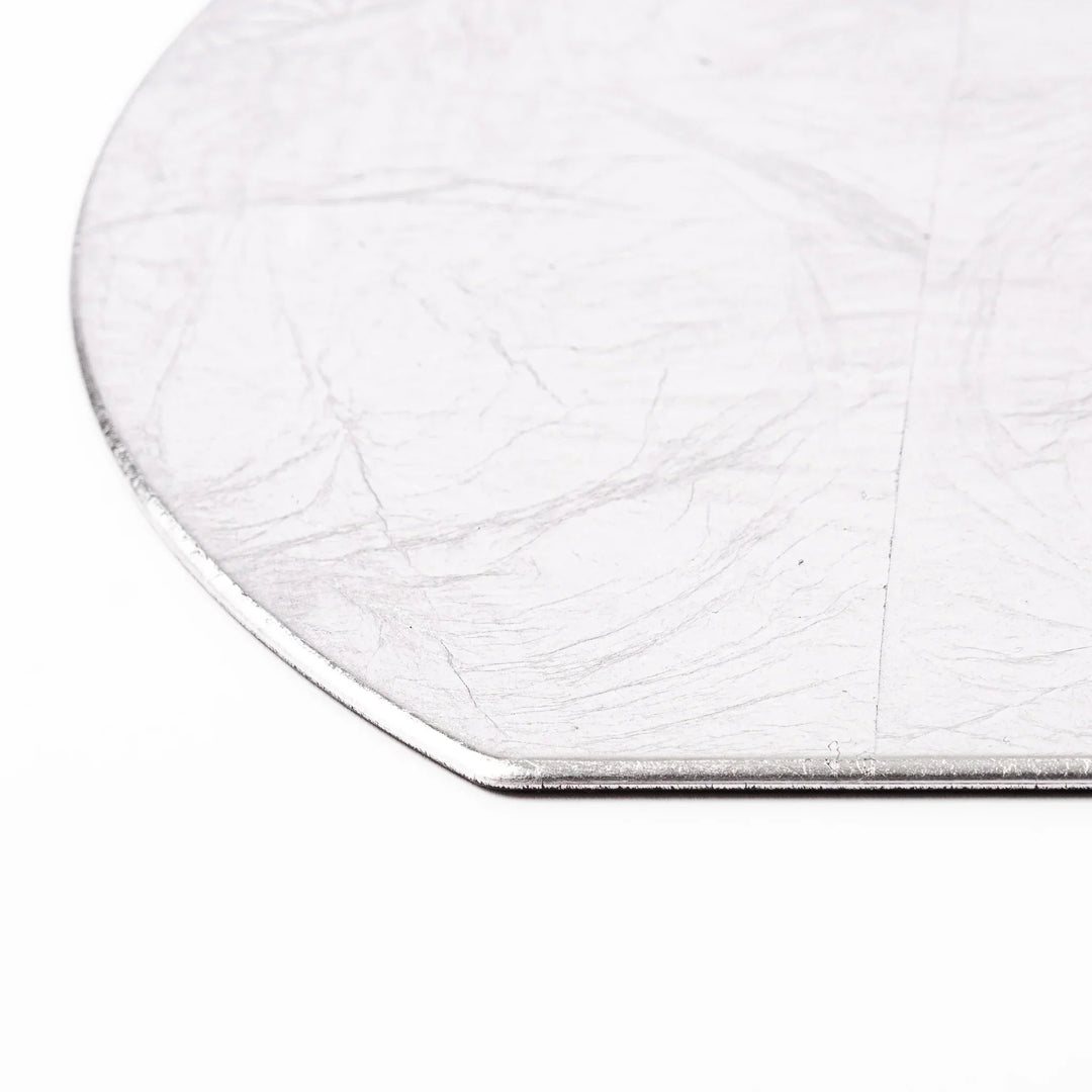 Silver Japanese Asanoha hemp leaf placemat with semicircular shape and embossed pattern for refined table.