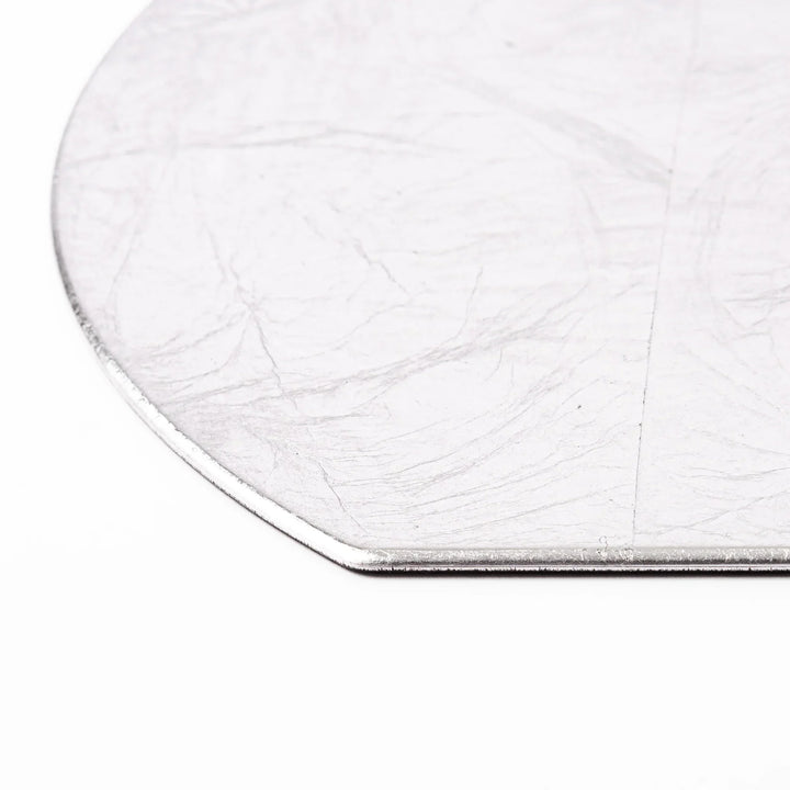 Silver Japanese Asanoha hemp leaf placemat with semicircular shape and embossed pattern for refined table.