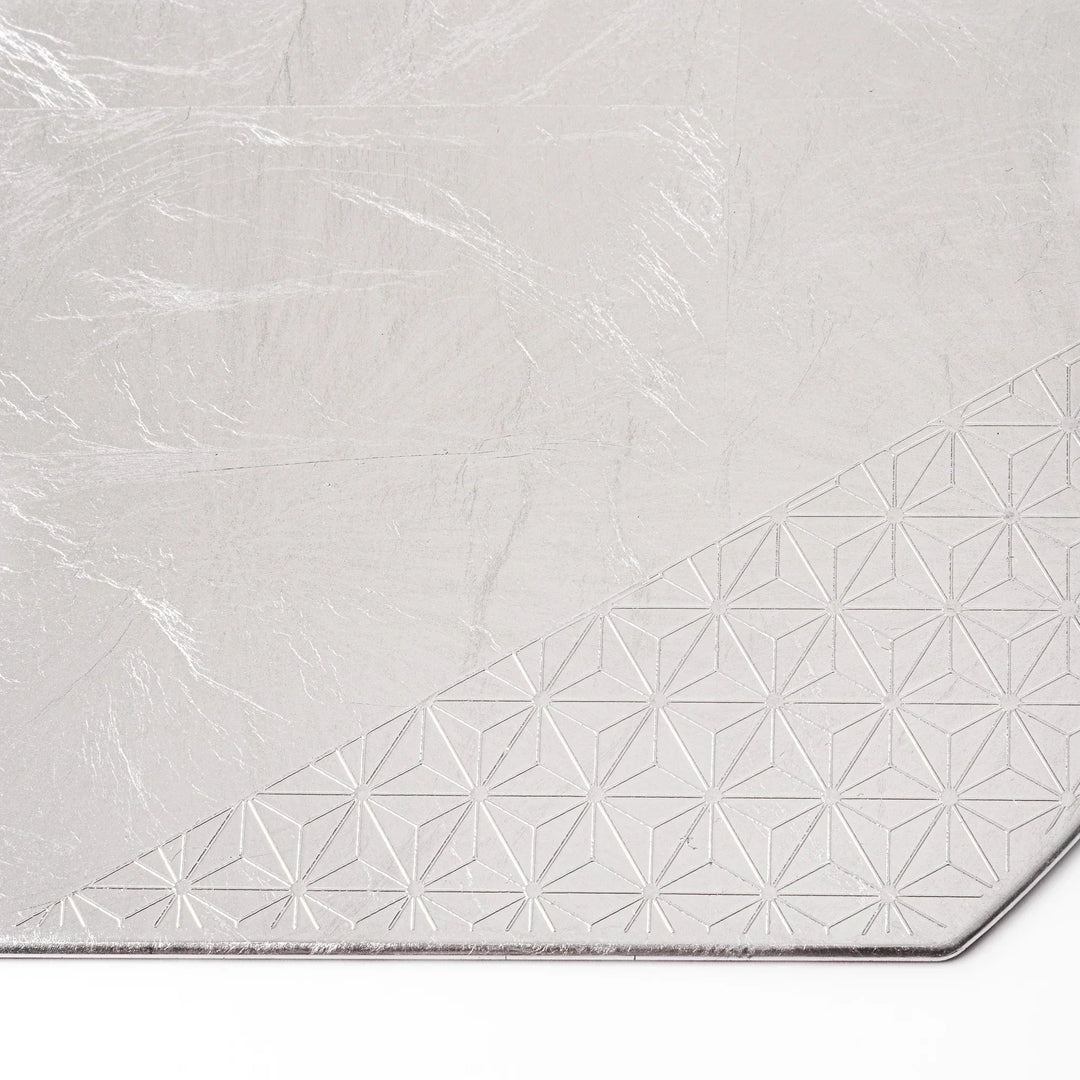 Silver Japanese Asanoha hemp leaf placemat with semicircular shape and embossed pattern for refined table.
