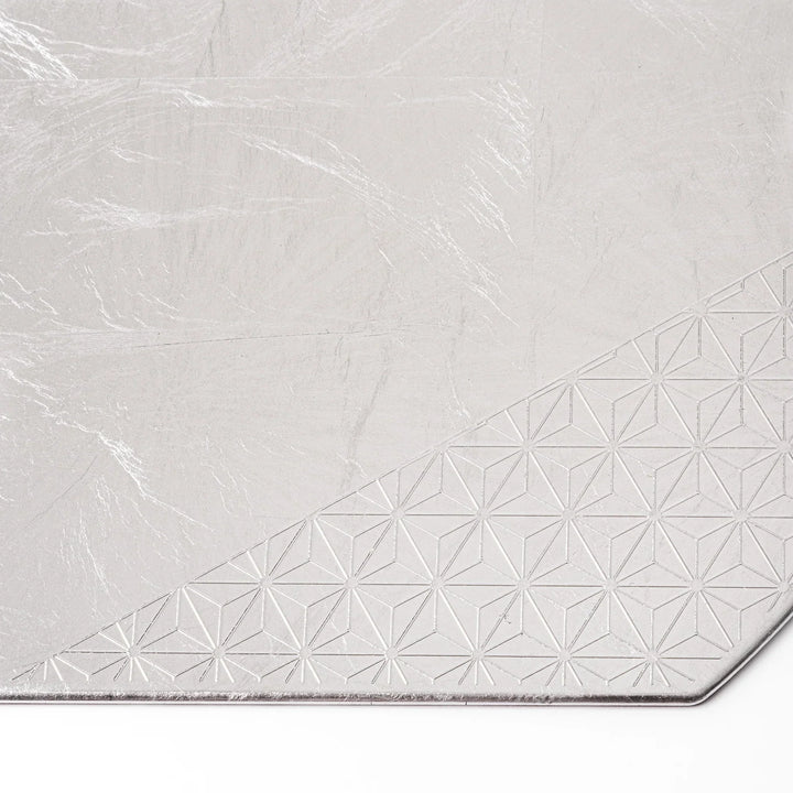 Silver Japanese Asanoha hemp leaf placemat with semicircular shape and embossed pattern for refined table.