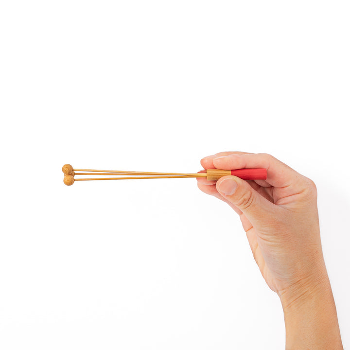 Single Japanese bamboo drink stirrer featuring a red handle top and wooden bead tips for mixing cocktails or tea
