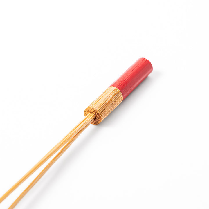 Single Japanese bamboo drink stirrer featuring a red handle top and wooden bead tips for mixing cocktails or tea
