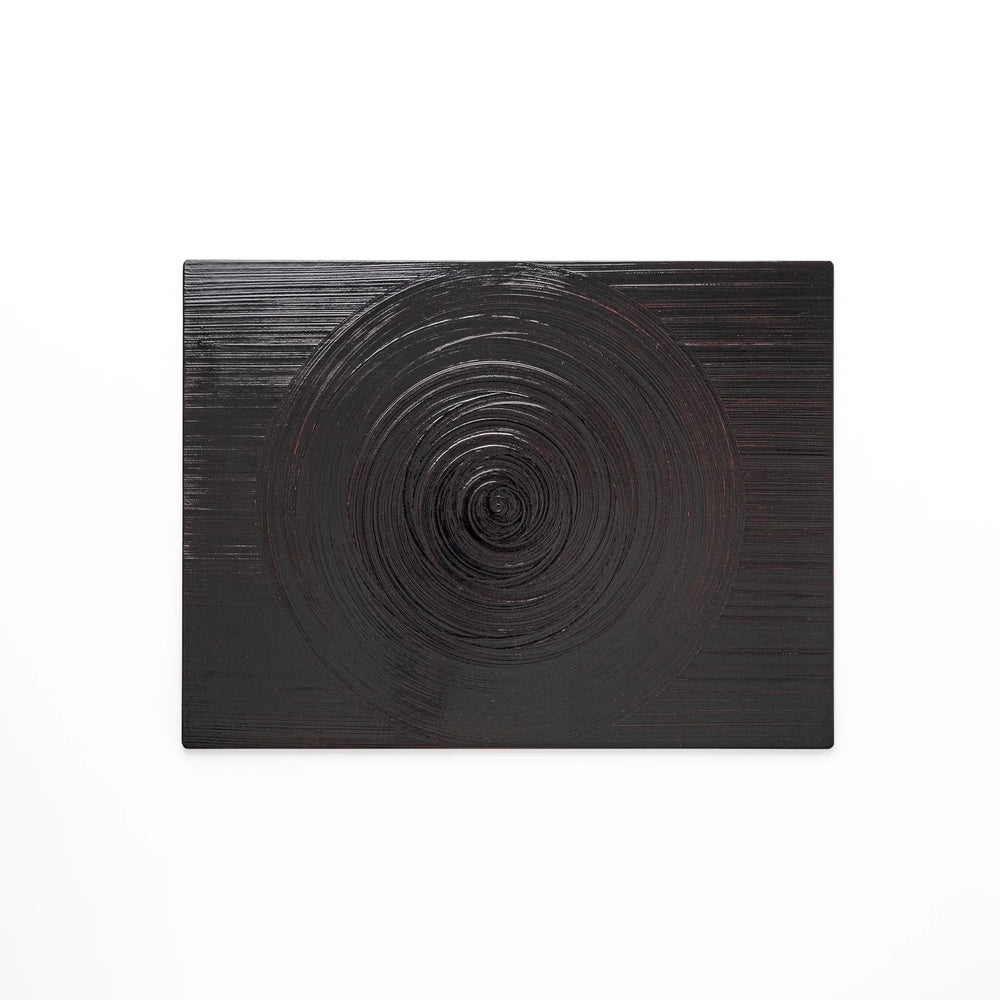 Reversible Japanese lacquer tray with circular brush texture in red and black for modern dining style.