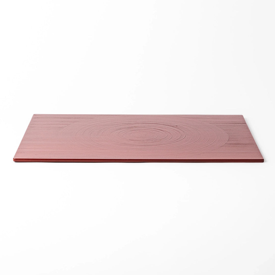 Reversible Japanese lacquer tray with circular brush texture in red and black for modern dining style.