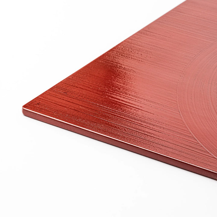 Reversible Japanese lacquer tray with circular brush texture in red and black for modern dining style.