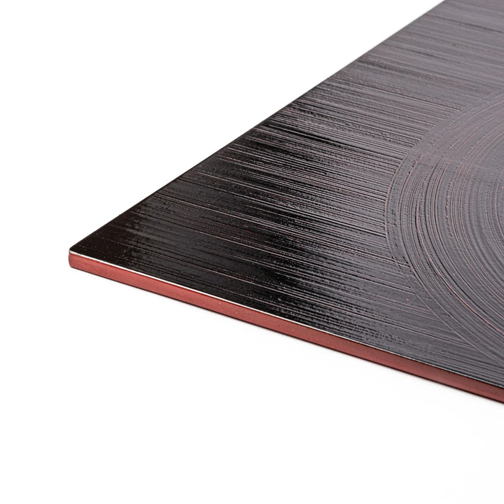 Reversible Japanese lacquer tray with circular brush texture in red and black for modern dining style.