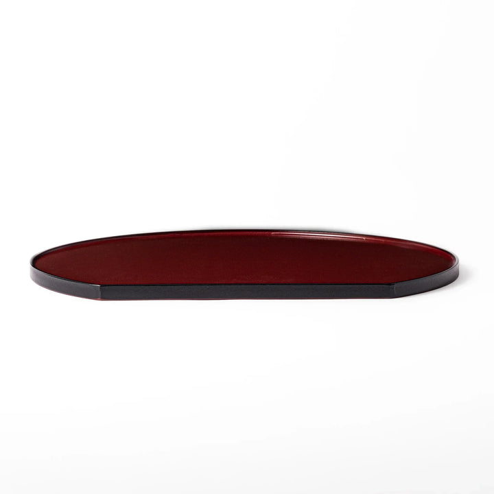Reversible Japanese half moon lacquer tray in red and black for minimalist and modern dining presentation.