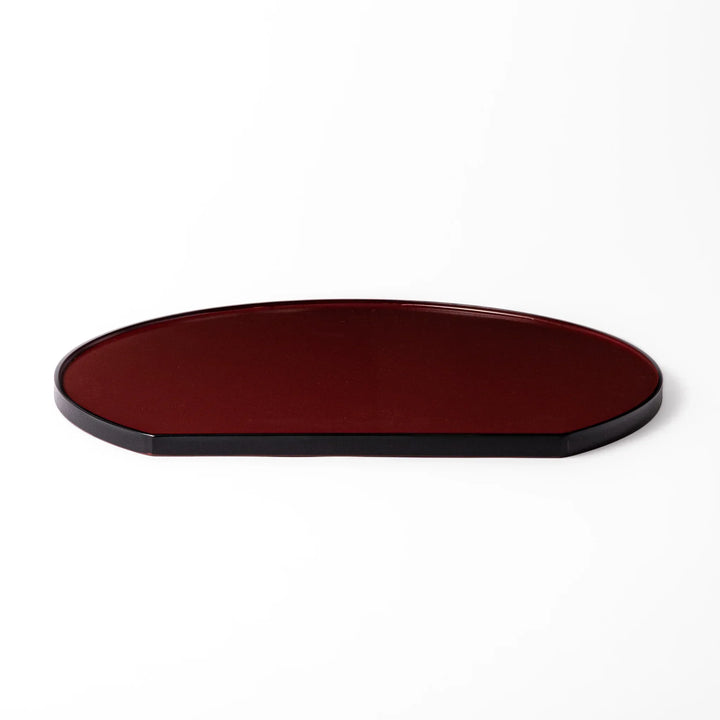 Reversible Japanese half moon lacquer tray in red and black for minimalist and modern dining presentation.