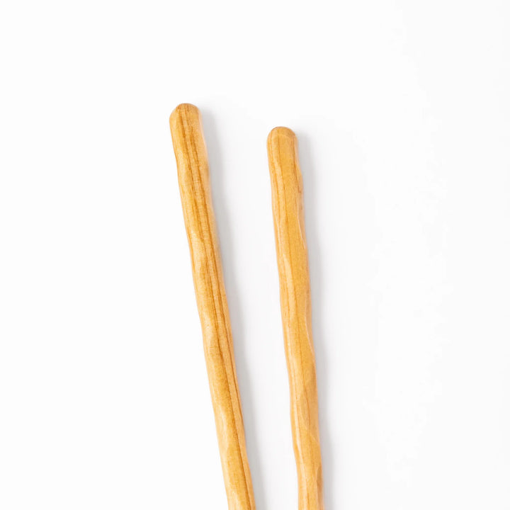 Japanese Hinoki wood carved chopsticks with textured hand-carved surface, lightweight design highlighting natural grain.