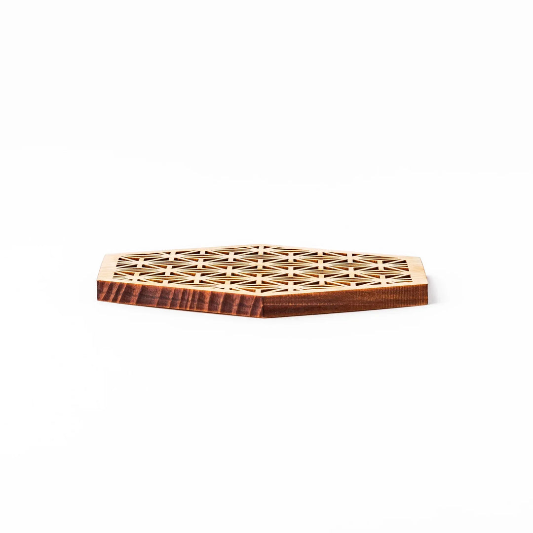 Hinoki wood coaster with a detailed hemp star cutout pattern in a hexagon shape against a white background.