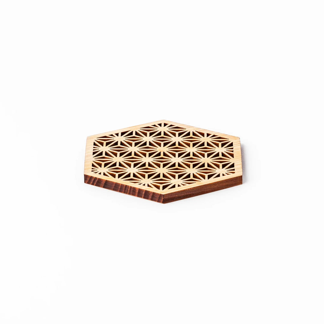 Hinoki wood coaster with a detailed hemp star cutout pattern in a hexagon shape against a white background.