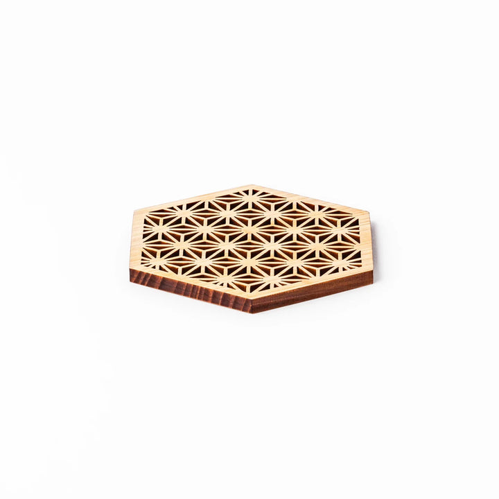 Hinoki wood coaster with a detailed hemp star cutout pattern in a hexagon shape against a white background.