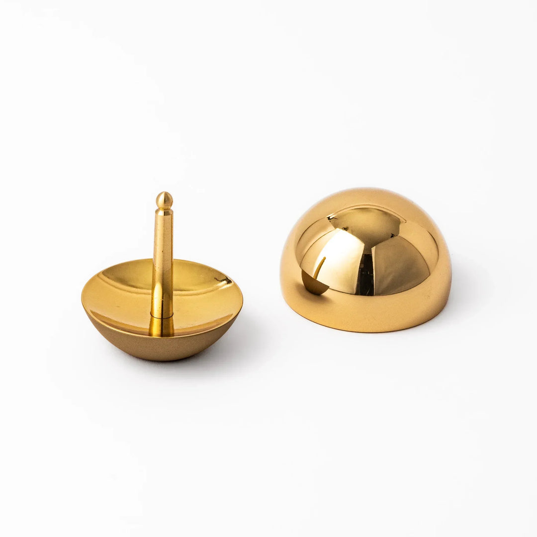 Japanese meditation and prayer chime with golden dome bell and wooden striker for mindfulness rituals.