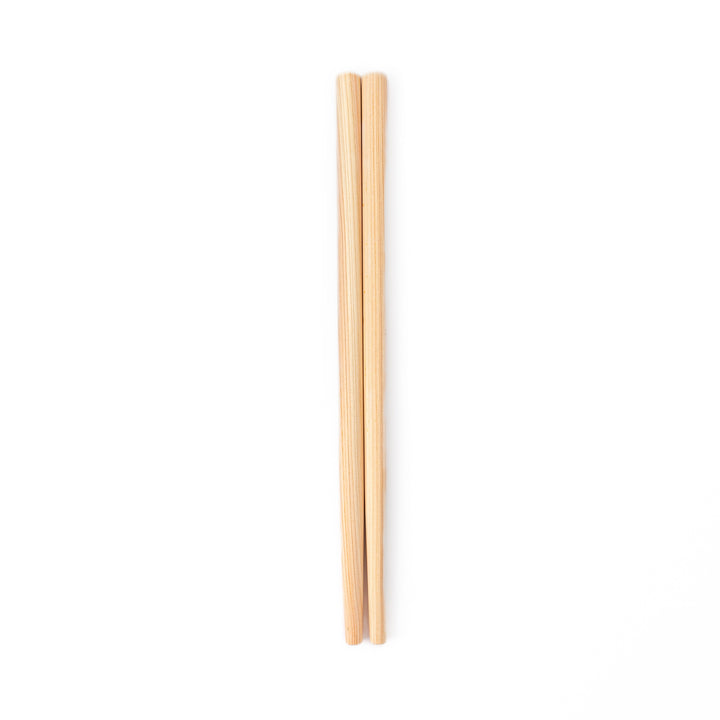 A pair of thick Japanese tempura cooking chopsticks made from light natural wood showcasing a minimalist and sturdy design