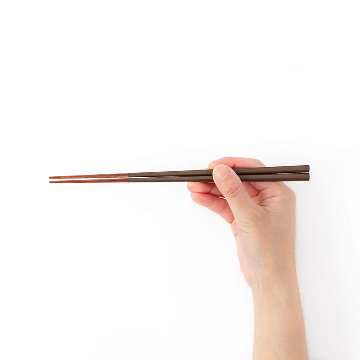 Pair of chestnut brown Japanese traditional color bamboo chopsticks with slim tips for refined and accurate dining
