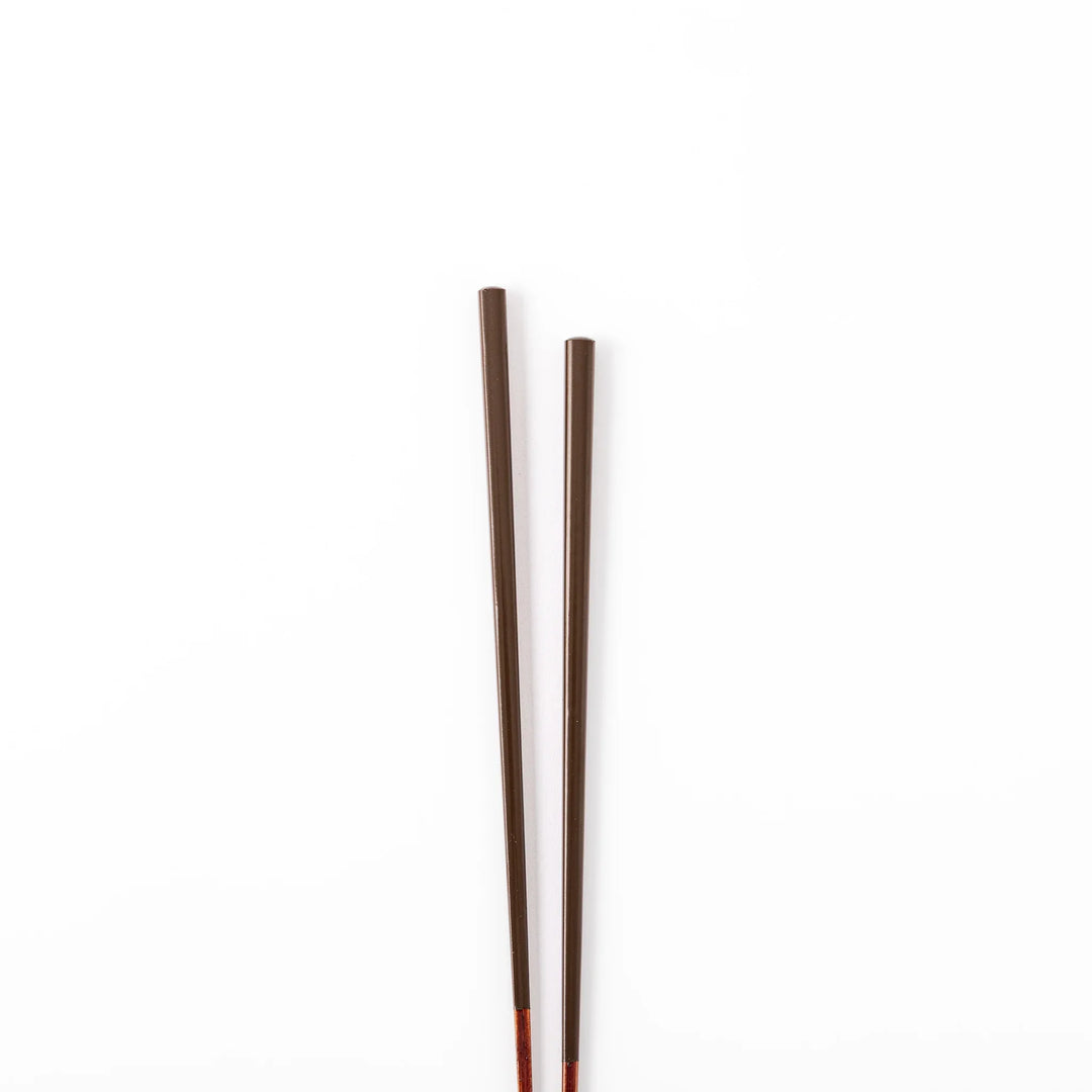 Pair of chestnut brown Japanese traditional color bamboo chopsticks with slim tips for refined and accurate dining