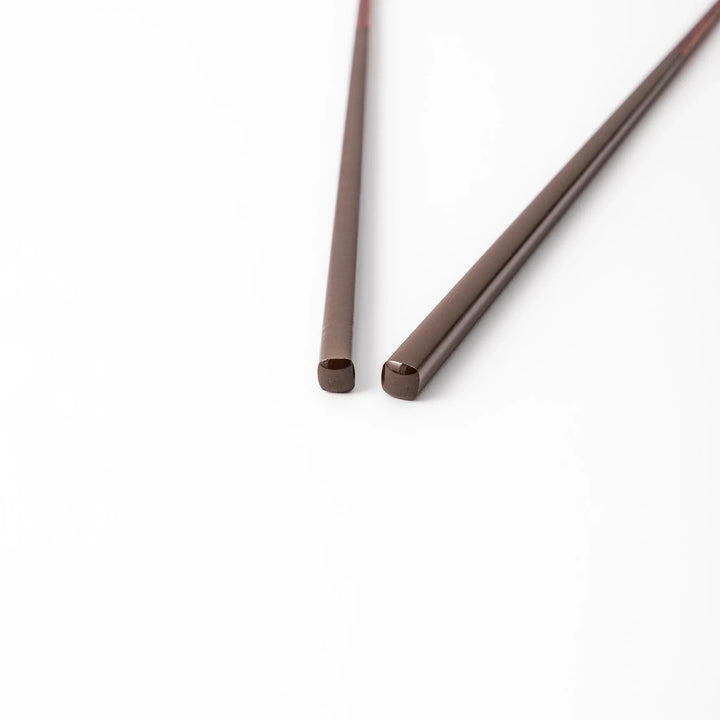 Pair of chestnut brown Japanese traditional color bamboo chopsticks with slim tips for refined and accurate dining