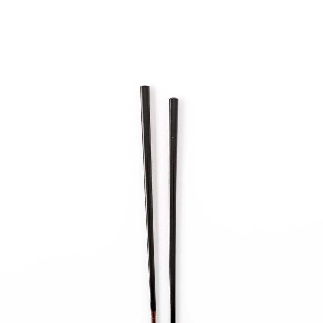 Pair of lacquer black Japanese traditional color bamboo chopsticks with fine tips for an elegant and precise dining experience