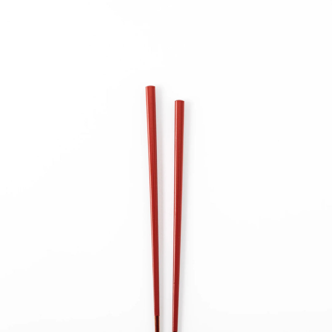 Pair of ancient vermillion red Japanese traditional color bamboo chopsticks with fine tips for an elegant dining experience