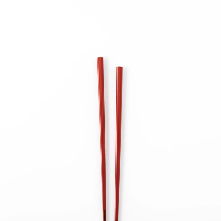 Pair of ancient vermillion red Japanese traditional color bamboo chopsticks with fine tips for an elegant dining experience