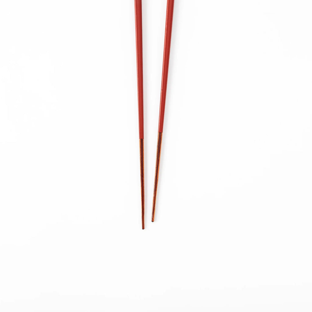 Pair of ancient vermillion red Japanese traditional color bamboo chopsticks with fine tips for an elegant dining experience