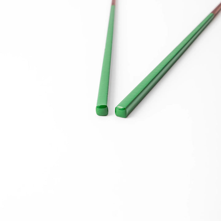 Pair of evergreen green Japanese traditional color bamboo chopsticks with fine tips for an elegant and precise dining experience