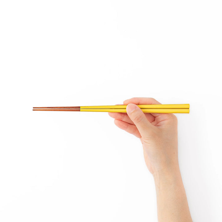 Pair of golden yellow Japanese traditional color bamboo chopsticks with fine tips for an elegant and precise dining experience