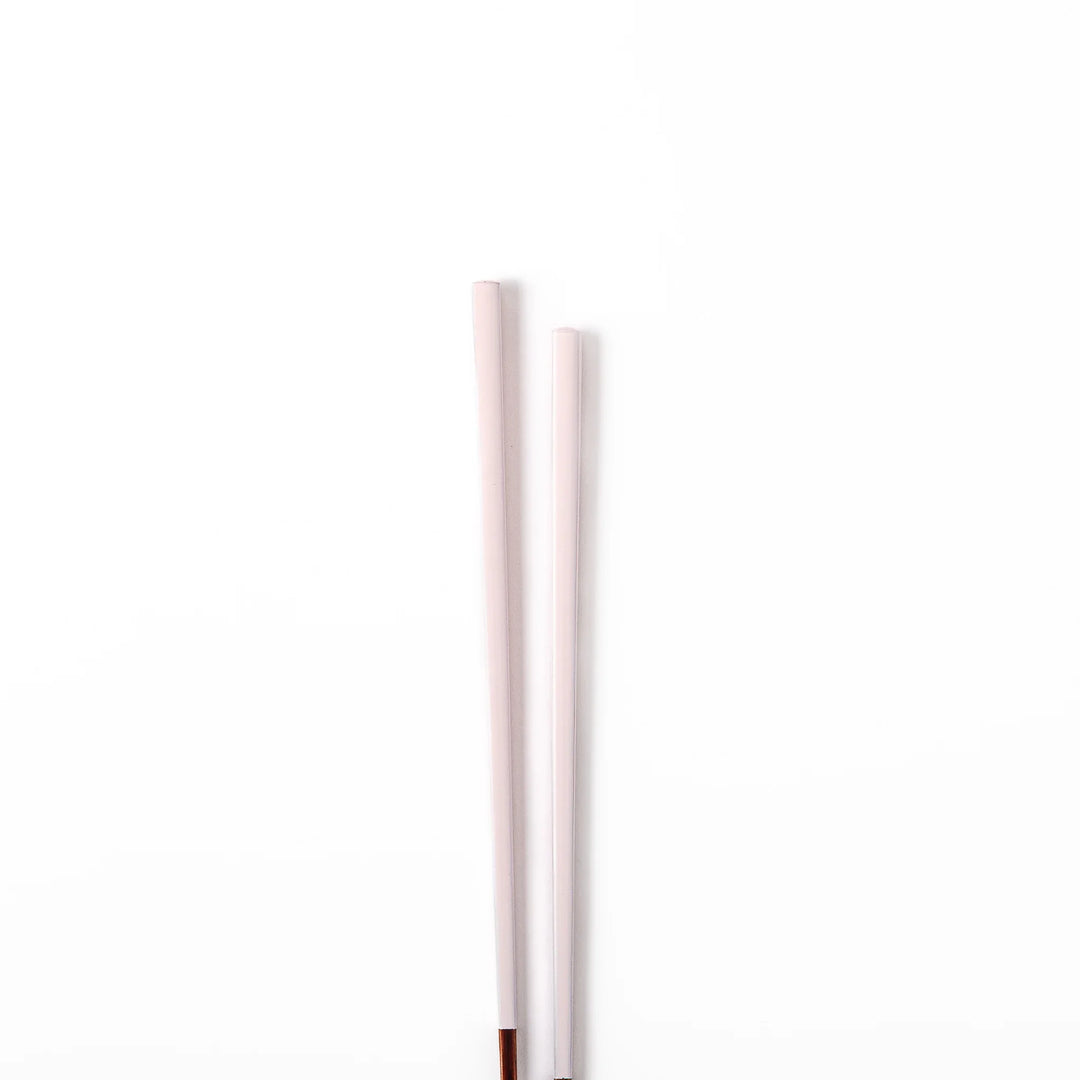 Pair of pale sakura pink Japanese traditional color bamboo chopsticks with fine tips for an elegant and precise dining experience