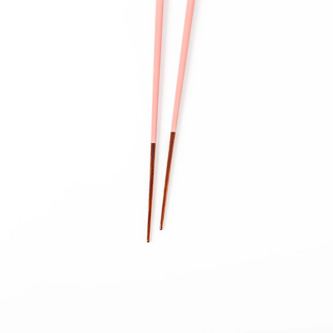 Pair of peach blossom pink Japanese traditional color bamboo chopsticks with fine tips for an elegant and precise dining experience