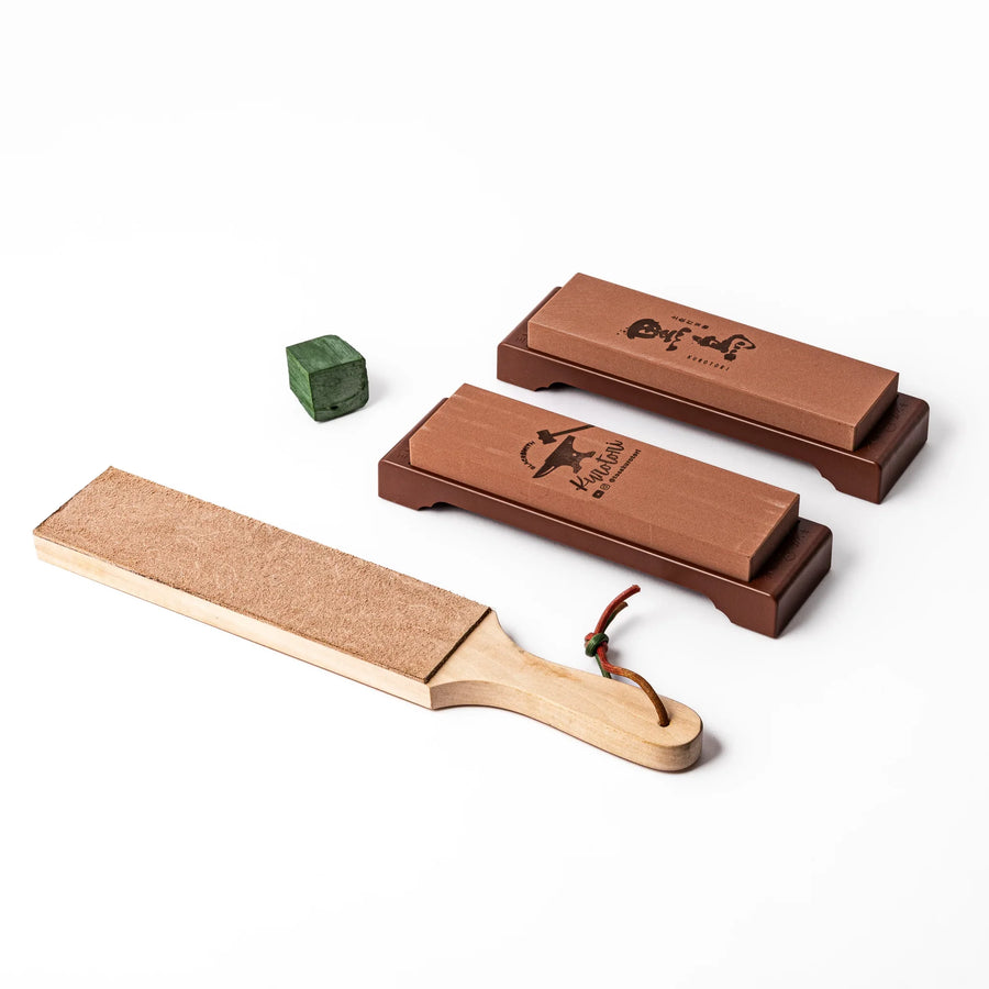 Japanese knife maintenance kit with whetstones leather strop and polishing compound for sharpening blades.