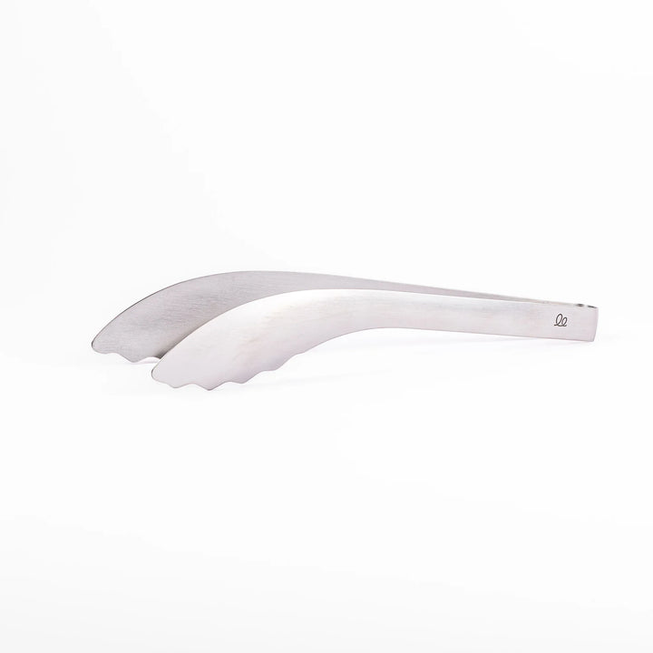 Japanese stainless steel kitchen tongs with slim curved tips for precise serving and plating