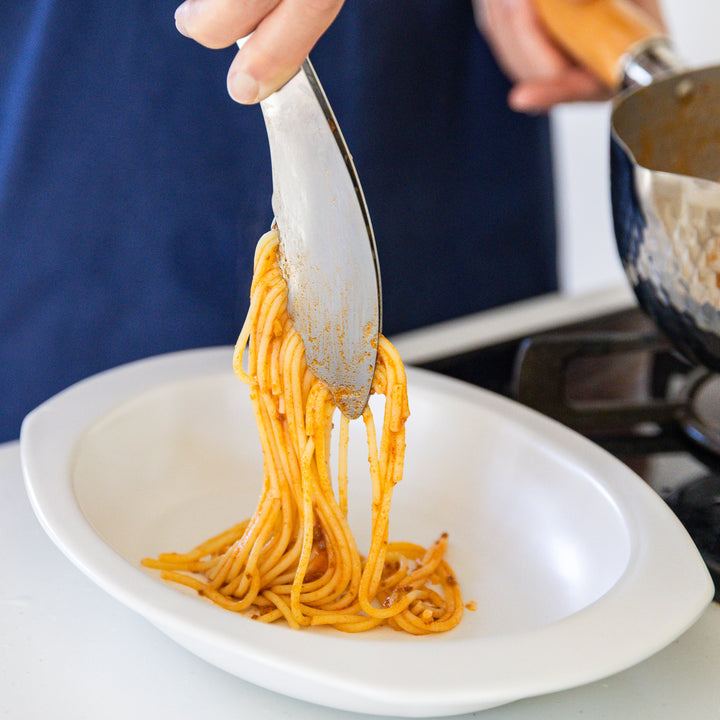 Nami from Just One Cookbook using Japanese stainless steel tongs to plate spaghetti from a Yukihira pan