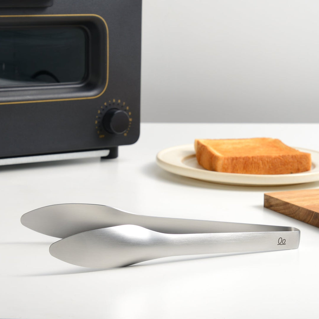 Hygienic stainless steel bread tongs with a built in stand that keeps the tips elevated off the kitchen counter