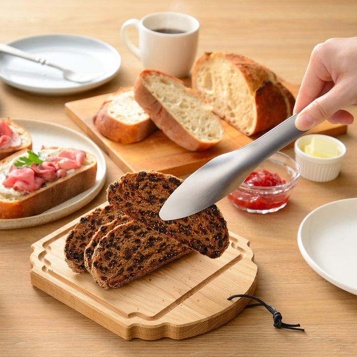 A beautiful breakfast spread with various breads and coffee featuring Japanese stainless steel tongs on the table