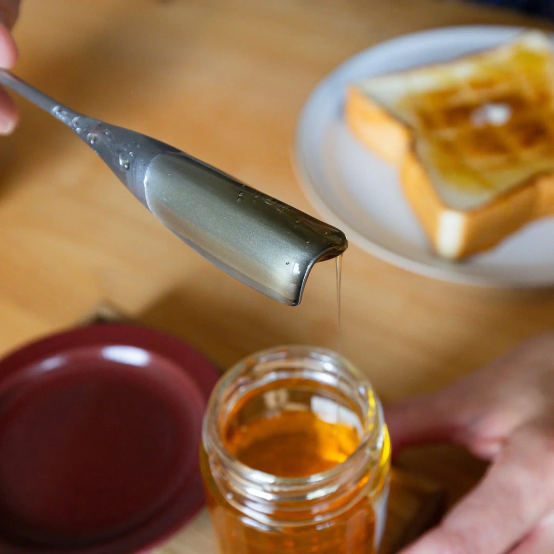Nami spinning aux japanese honey spoon to cut dripping syrup cleanly over glass jar unique stainless steel drizzler