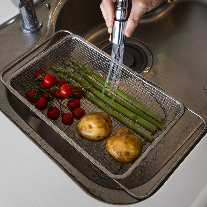 Nami from Just One Cookbook washing fresh tomatoes asparagus and potatoes in a stainless steel expandable draining basket