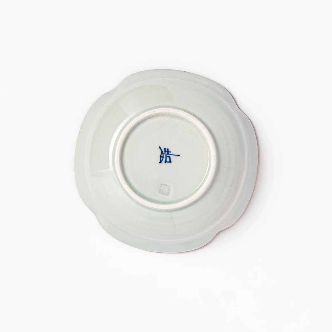 White ceramic cereal bowl with a scalloped rim, decorated inside with blue leaf motifs and a brown-accented edge.