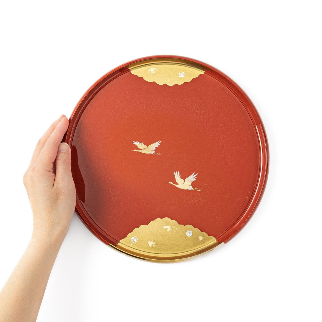 Japanese lacquer serving tray with flying crane motif in gold on red finish elegant round design for traditional table setting