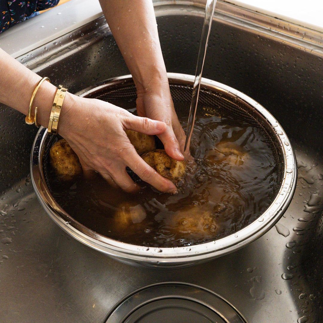 Extra large Japanese stainless steel mixing bowl and strainer, ideal for washing heavy root vegetables in the sink