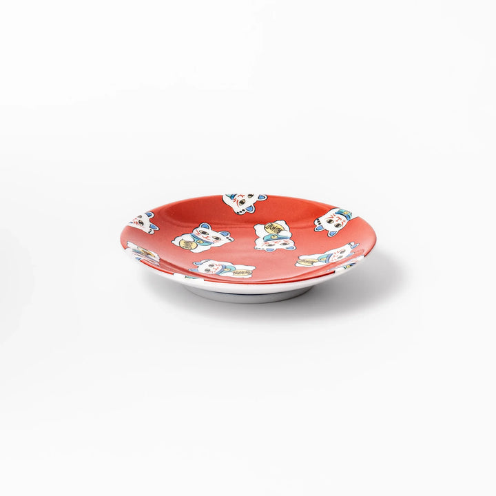 Round Japanese ceramic sauce dish with red background and maneki neko cat design for soy sauce or condiments.