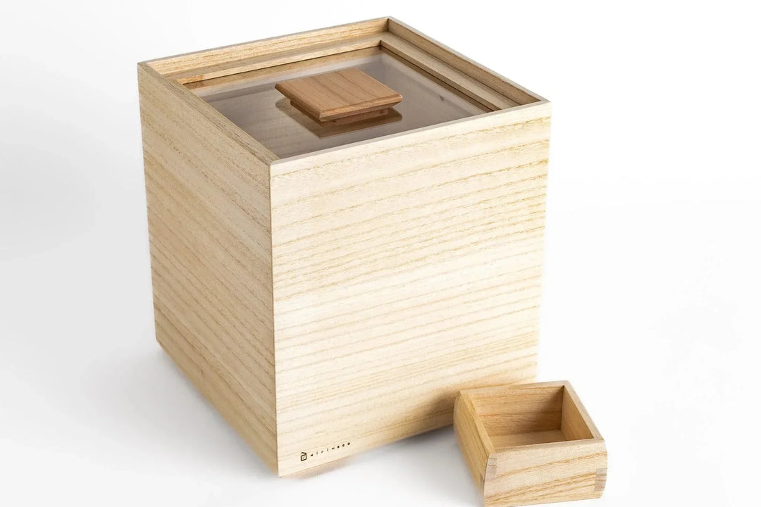 Lightweight kiri wood storage box with sliding lid and small measuring cup displayed on a white background