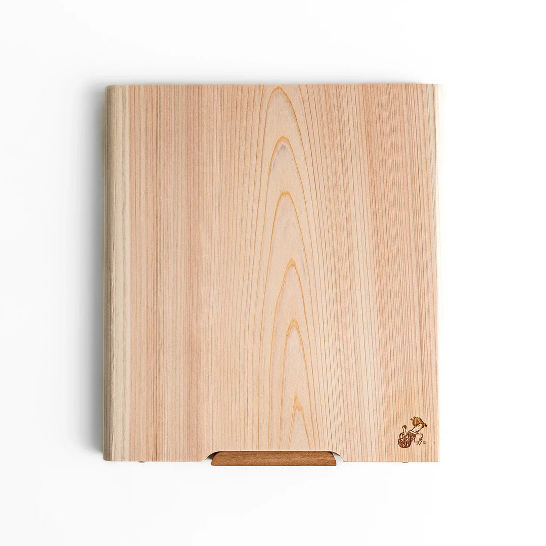 Medium Hinoki wood cutting board with natural grain, side handle, engraved motif, and smooth finish, crafted in Japan