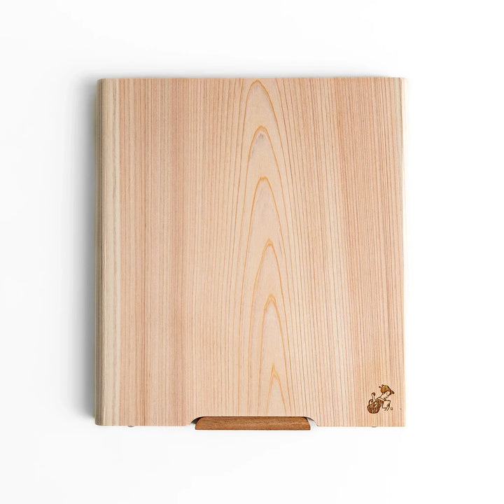 Medium Hinoki wood cutting board with natural grain, side handle, engraved motif, and smooth finish, crafted in Japan