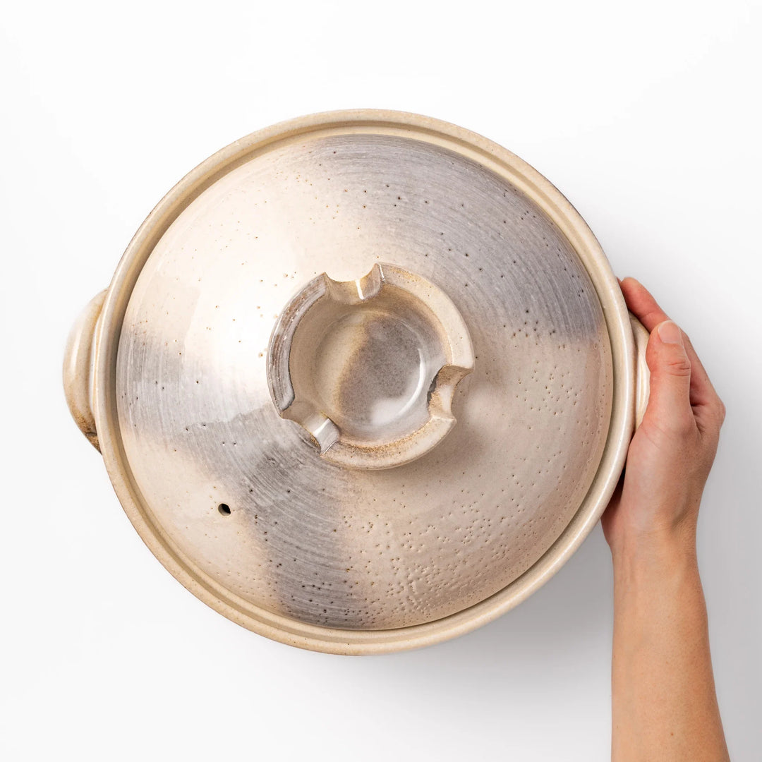 Japanese donabe clay pot with misty beige glazed lid and handles ideal for family hot pot and slow cooking.