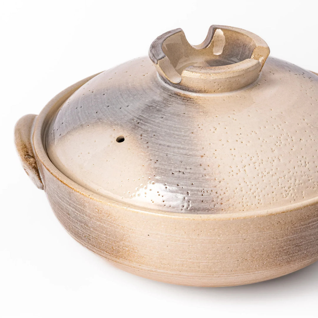 Japanese donabe clay pot with misty beige glazed lid and handles ideal for family hot pot and slow cooking.