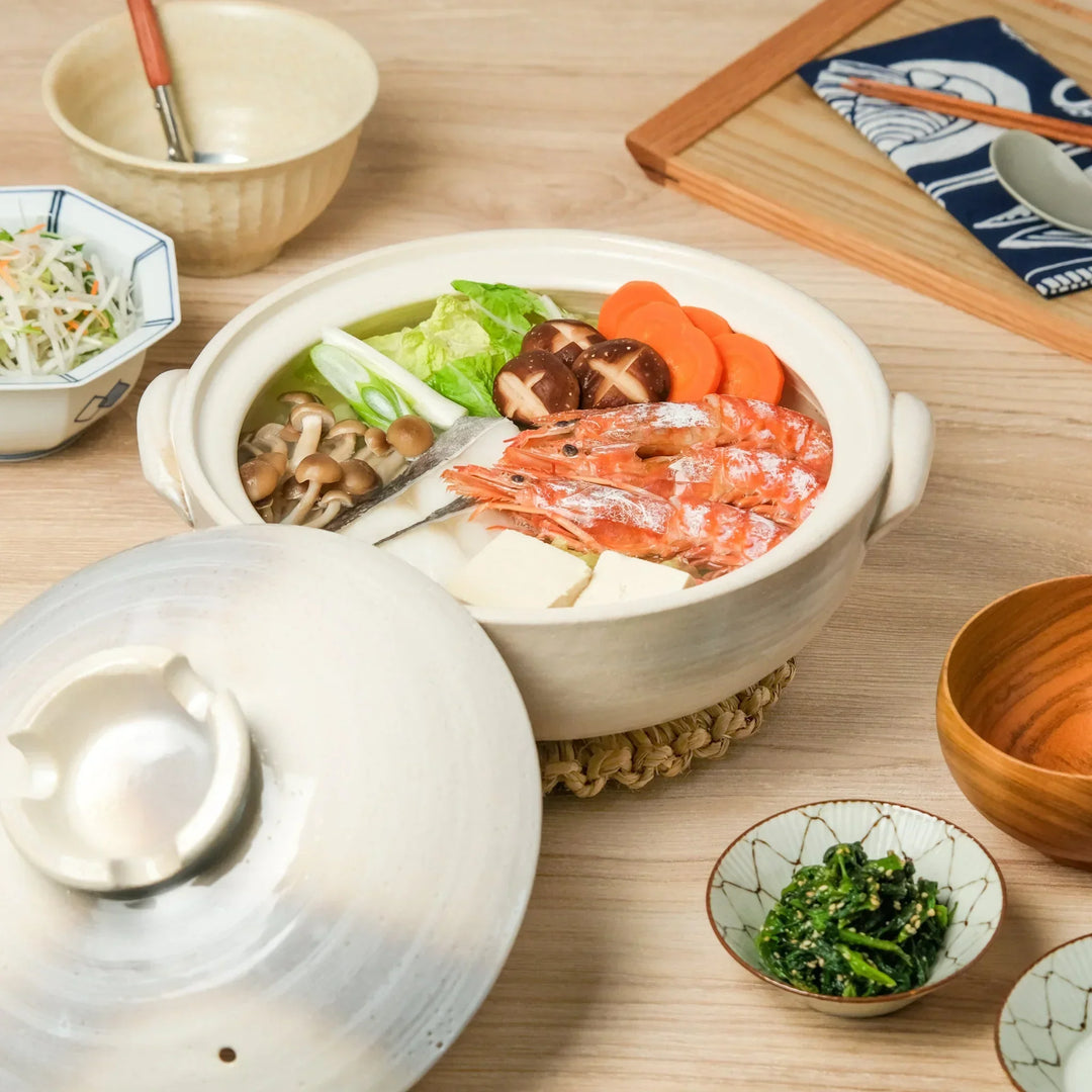 Japanese donabe clay pot with misty beige glazed lid and handles ideal for family hot pot and slow cooking.