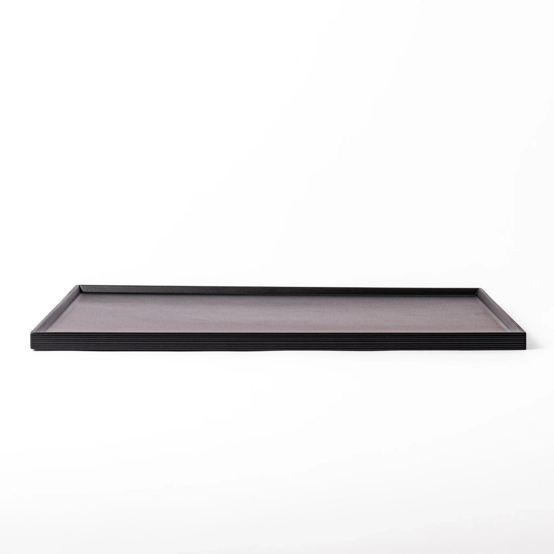 Modern Japanese black lacquer serving tray with horizontal grain texture and side grooves for easy use.