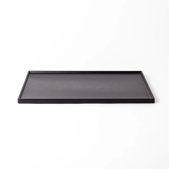 Modern Japanese black lacquer serving tray with horizontal grain texture and side grooves for easy use.